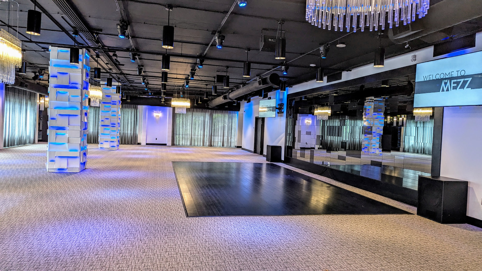 Empty main event space at The MEZZ with blue programmable lighting