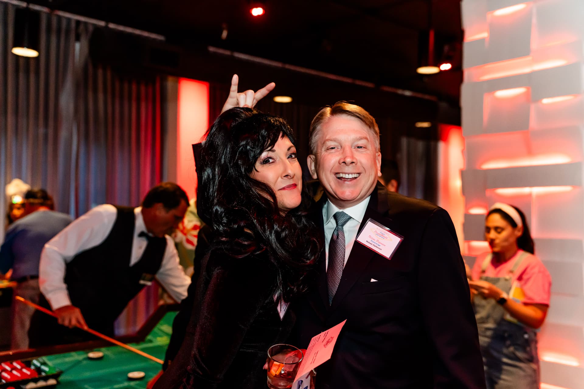 Name-badged guests talking during a corporate event in the main event space at The MEZZ